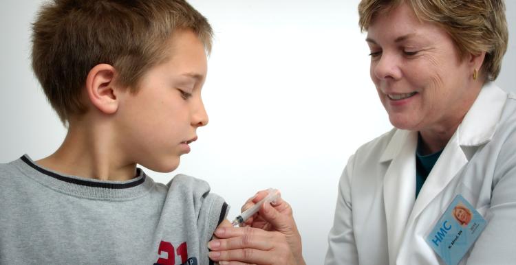 Young boy and nurse receiving flu vaccine 