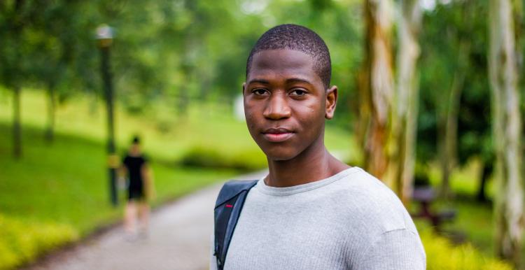Young man standing outside looking at the camera