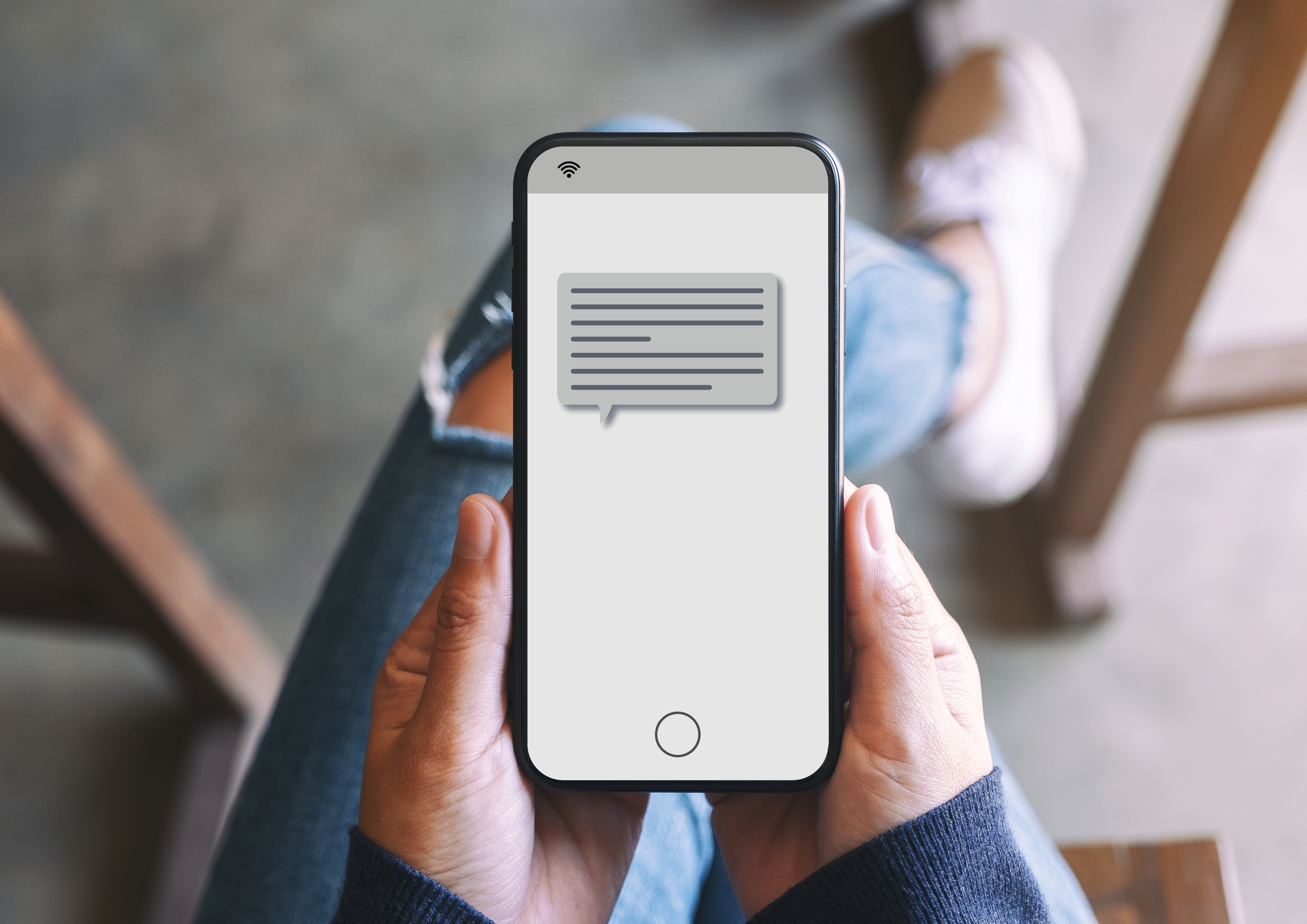 Female holding phone with text message showing