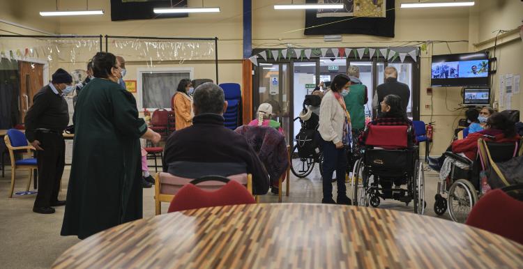 Crowd of people gathered in an entrance.