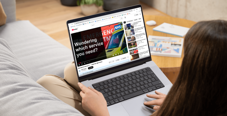 Lady watching range of NHS services video on her laptop