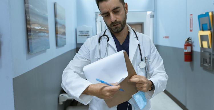 Doctor in a hospital reading patient notes