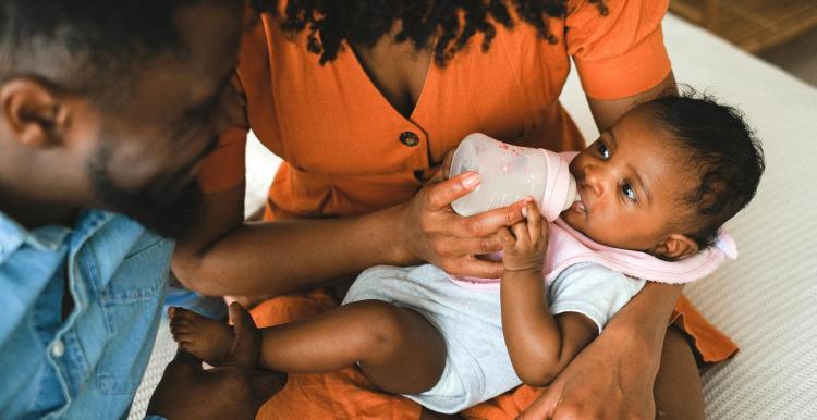 Mother and father feeding their baby