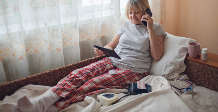 Lady laying in her bed, virtual ward.