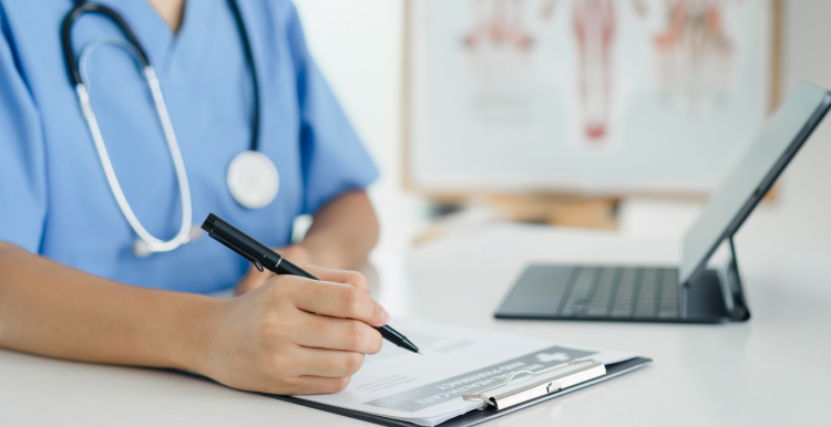 A nurse filling in a form