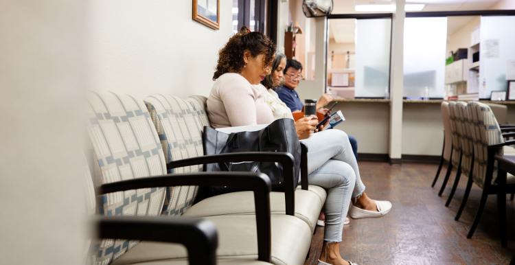 People sitting on chairs in a waiting room