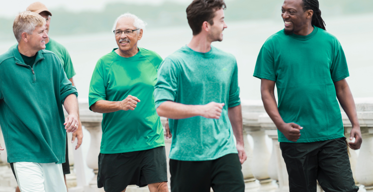 Five men, different ages walking and talking