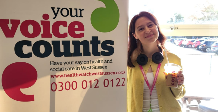 Eve, one of our student volunteers standing in front of our banner at an event 
