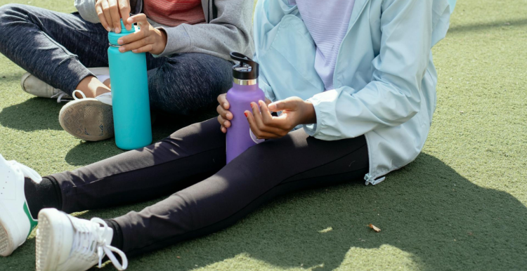 Tired girls resting on sports ground