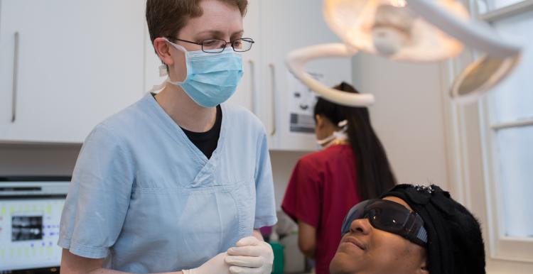 Dentist with patient in chair