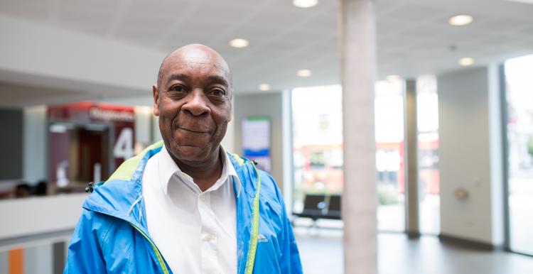 Man standing in a hospital smiling