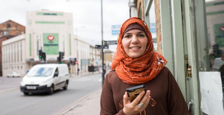 Lady smiling, holding her phone