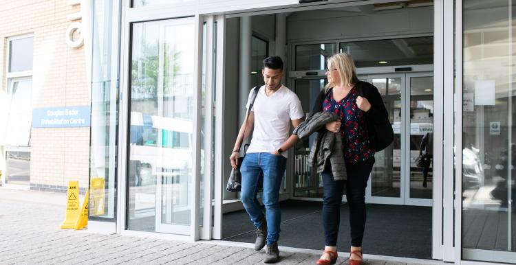 Man and woman walking out of hospital