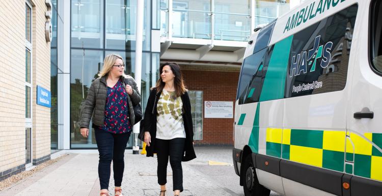 Women walking outside a hospital