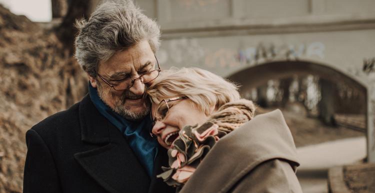 couple holding hands and laughing