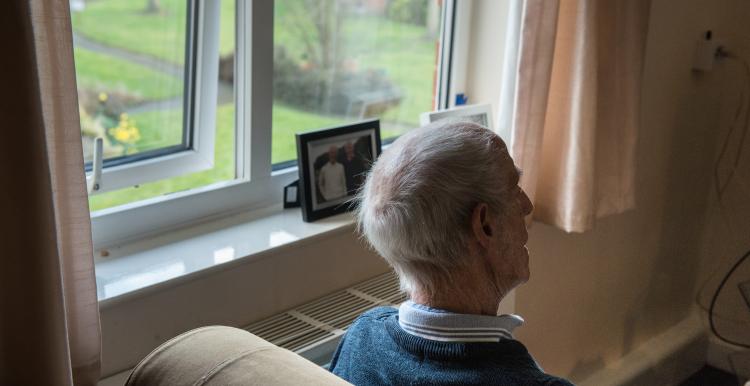 Older man looking out window. Image from Centre for Ageing Better
