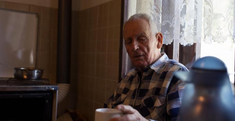 Man sitting at home with cup of tea