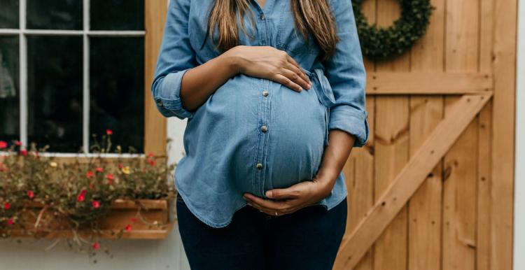 Pregnant female holding her belly