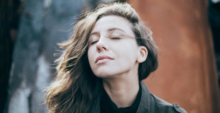 Lady standing outside breathing in air