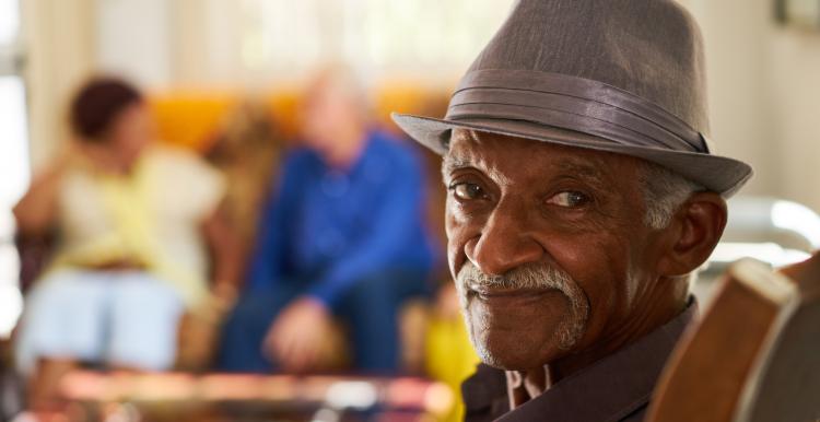 Man smiling at the camera in a care home