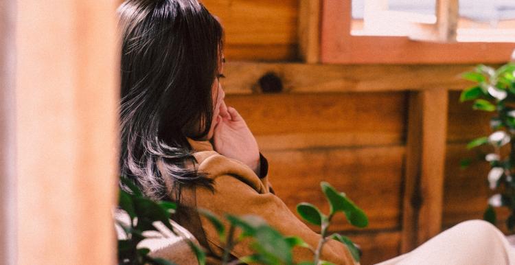 Woman sitting in a chair while thinking