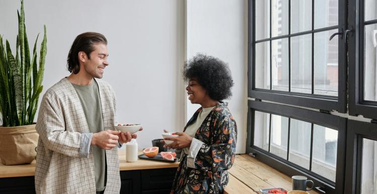 Male and female eating breakfast and chatting