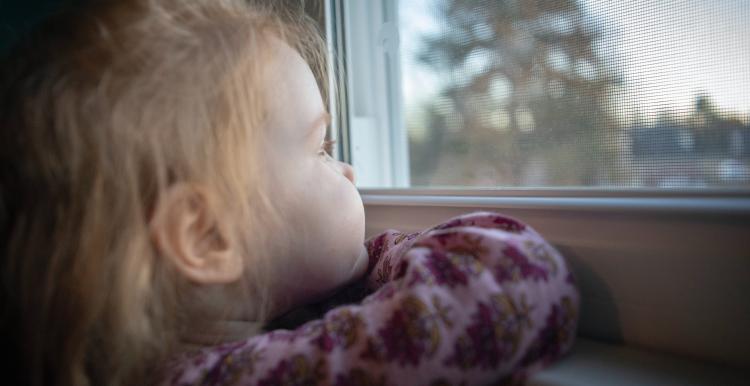 Young child looking out the window
