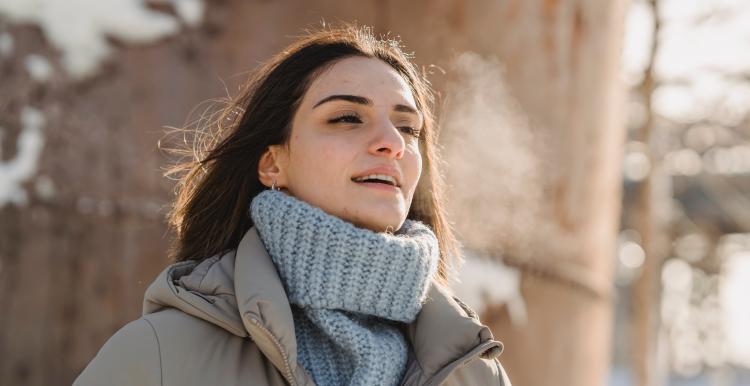 woman outside during winter breathing the air