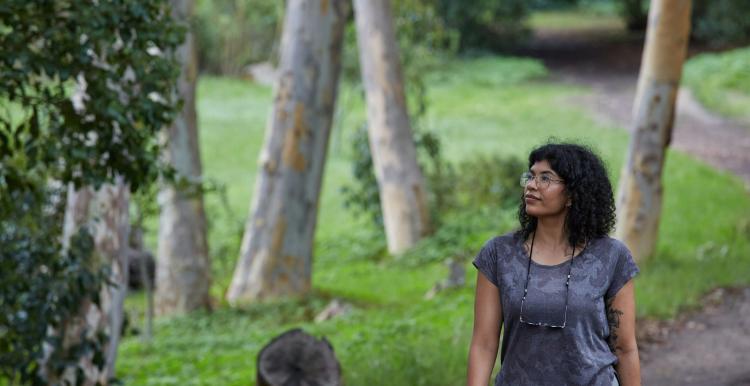 Lady walking amongst trees
