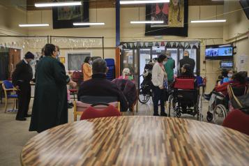 Crowd of people gathered in an entrance.