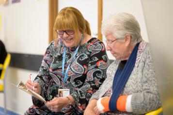Healthwatch volunteer chatting with a lady