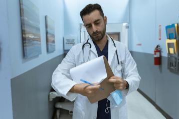 Doctor in a hospital reading patient notes