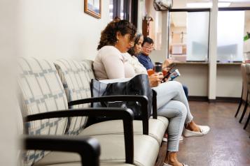 People sitting on chairs in a waiting room