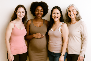Four women different ages and ethnicity smiling at the camera