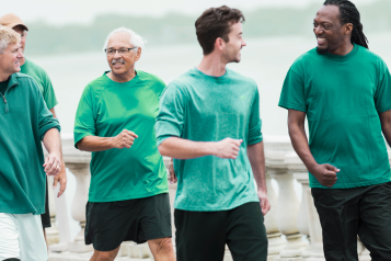 Five men, different ages walking and talking