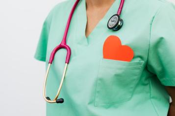 A healthcare professional with a stethoscope and red heart symbol.