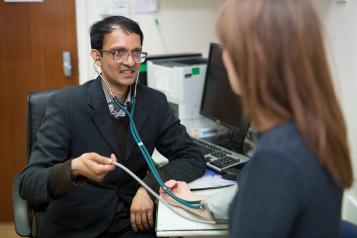 GP staff member with patient