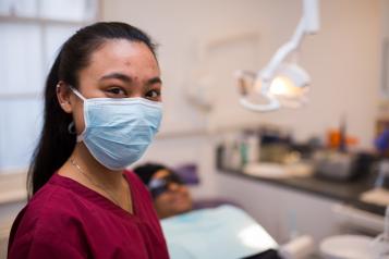 Dentist with patient in chair
