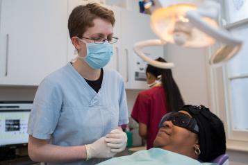 Dentist with patient in chair