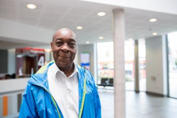 Man standing in a hospital smiling