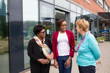 3 ladies talking outside a hospital