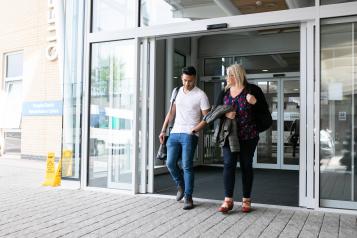 Man and woman walking out of hospital