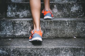 Lady running up steps in exercise shoes