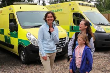 Ladies standing by an ambulance