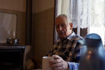 Man sitting at home with cup of tea