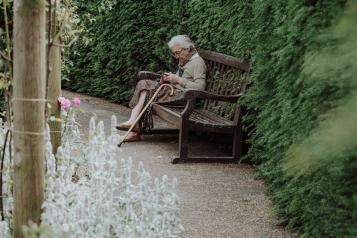 Older lady sitting in garden