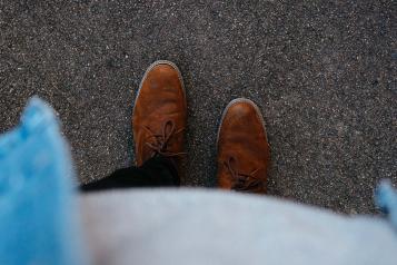 person wearing brown leather shoes