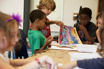 group of children looking at a book