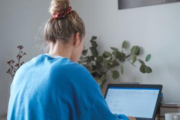 Girl sitting at laptop at home