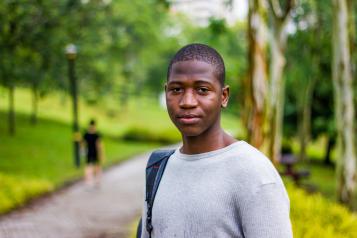Young man standing outside looking at the camera